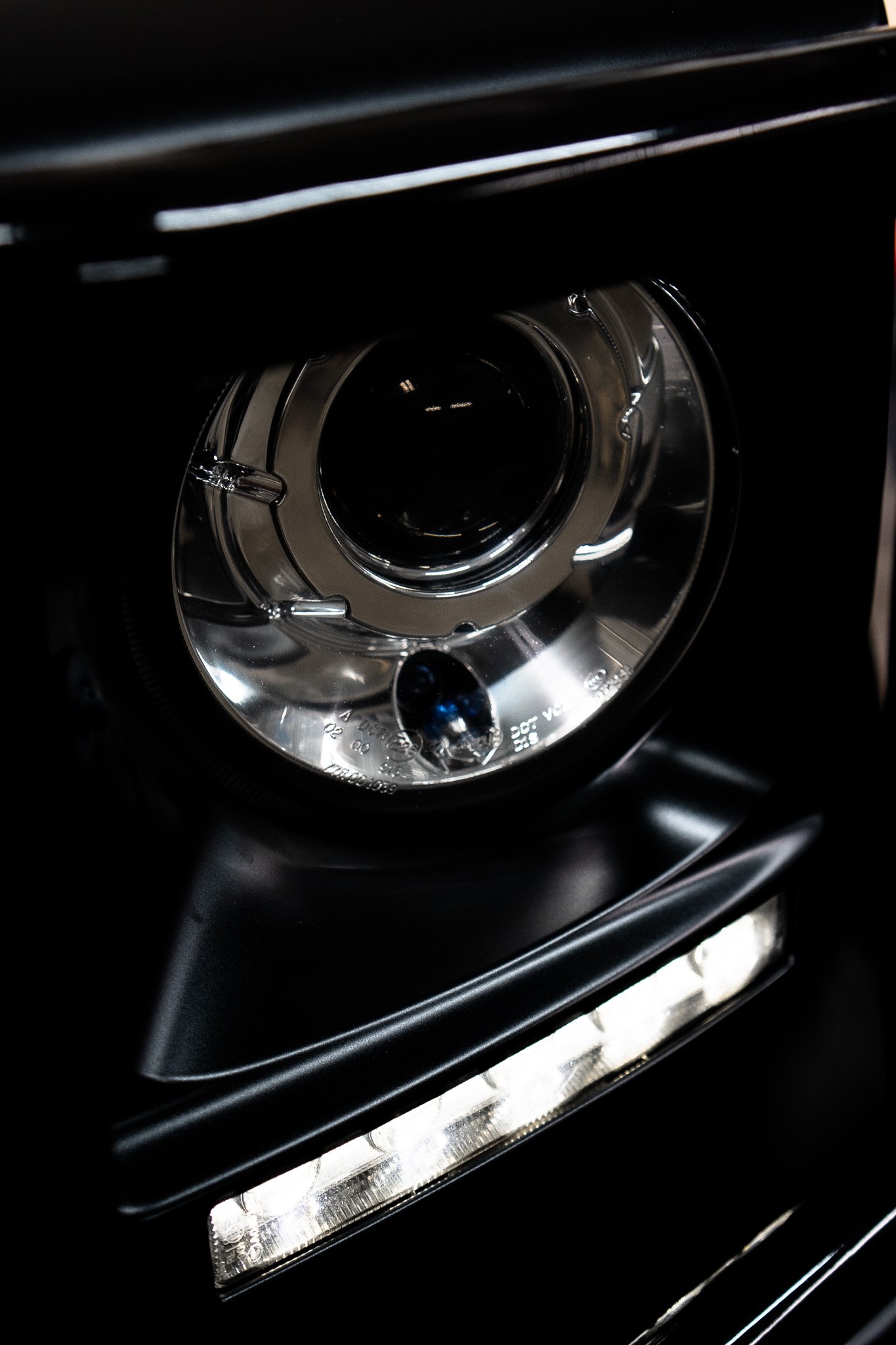 Close-up of a European car headlight at Eurohaus Motorsports